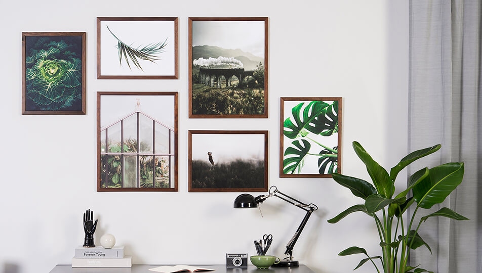 Mur d'images dans bureau - cadres en bois fonc et motifs de nature verts